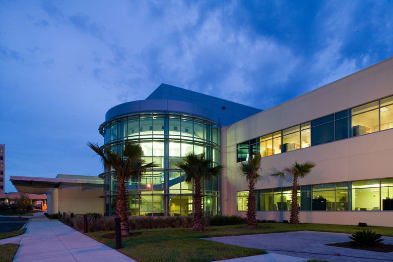 UF Health Proton Therapy Institute exterior at dusk