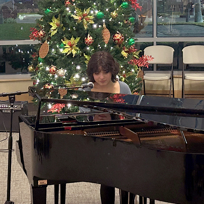 Brain tumor survivor Vania Q playing the piano